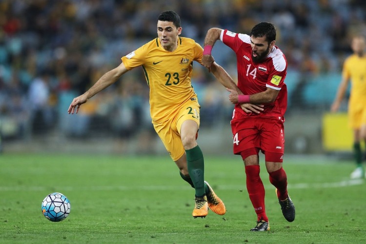 TOM ROGIC of Australia and Tamer Mohamd of Syria compete during the 2018 FIFA World Cup Asian Playoff match between the Australian Socceroos and Syria at ANZ Stadium in Sydney, Australia.
