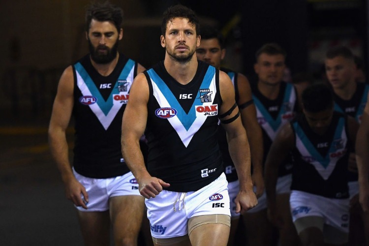 TRAVIS BOAK of the Power leads his team out onto the field during the AFL match between the North Melbourne Kangaroos and Port Adelaide Power at Etihad Stadium in Melbourne, Australia.