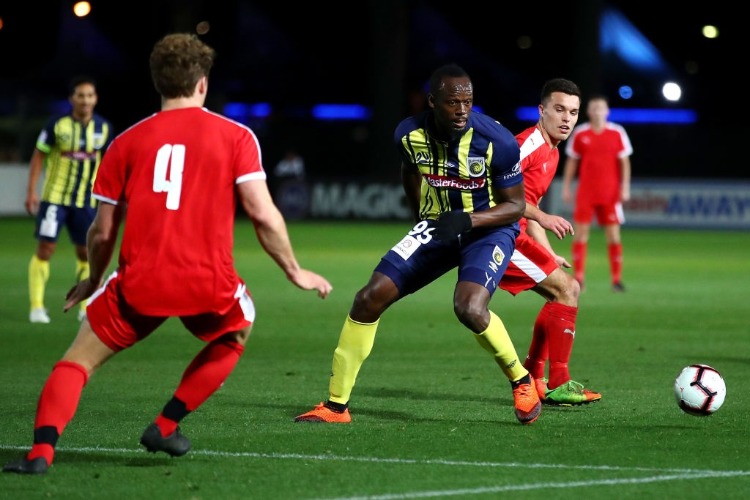 USAIN BOLT of the Mariners controls the ball during the pre-season match between the Central Coast Mariners and Central Coast Football at Central Coast Stadium in Gosford, Australia.