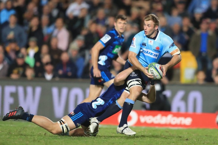 WILL MILLER of the Waratahs looks to pass the ball during the Super Rugby match between the Waratahs and the Blues at Lottoland in Sydney, Australia.