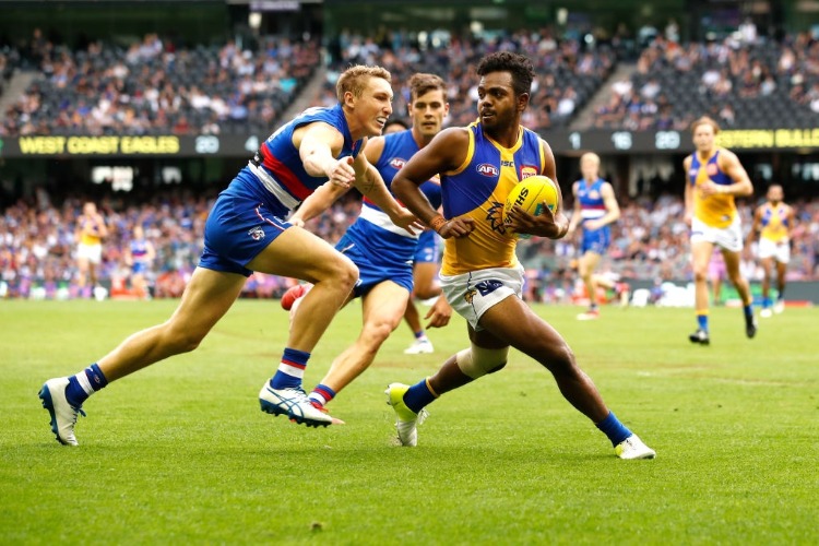 WILLIE RIOLI of the Eagles evades Bailey Dale of the Bulldogs during the 2018 AFL match between the Western Bulldogs and the West Coast Eagles at Etihad Stadium in Melbourne, Australia.