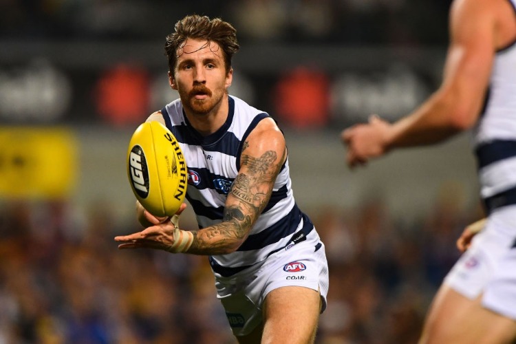 ZACH TUOHY of the Cats handpasses the ball during the 2017 AFL match between the West Coast Eagles and the Geelong Cats at Domain Stadium in Perth, Australia.