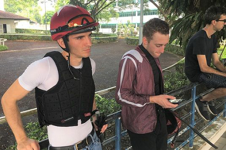 Luan Machado (left) takes in the atmosphere at the trainer's hut at Kranji during the Tuesday barrier trials.