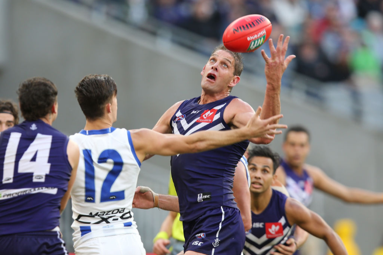 AARON SANDILANDS of the Dockers juggles the ball during the AFL match between the Fremantle Dockers and the North Melbourne Kangaroos at Optus Stadium in Perth, Australia.