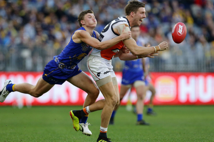 AIDAN CORR of the Giants handpasses the ball during the AFL match between the West Coast Eagles and the Greater Western Sydney Giants at Optus Stadium in Perth, Australia.