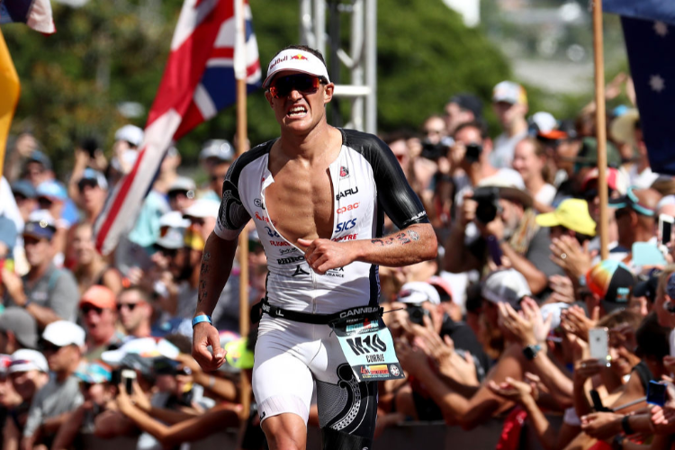 BRADEN CURRIE of New Zealand celebrates after finishing during the IRONMAN World Championships brought to you by Amazon in Kailua Kona, Hawaii.