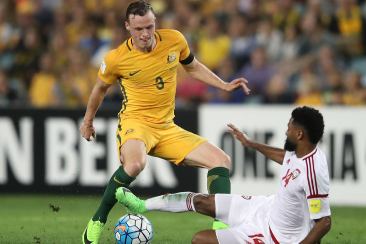 BRAD SMITH of the Socceroos is tackled by Abdelaziz Sanqour of the United Arab Emirates during the FIFA World Cup Qualifier match between the Australian Socceroos and United Arab Emirates at Allianz Stadium in Sydney, Australia.