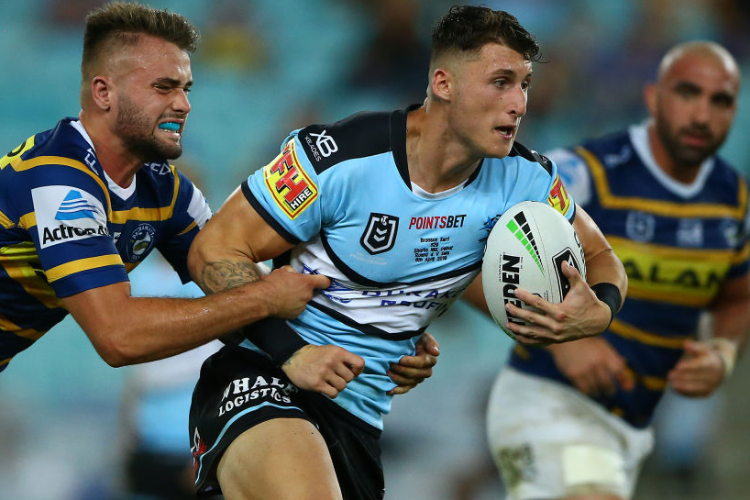 BRONSON XERRI of the Sharks is tackled during the NRL match between the Parramatta Eels and the Cronulla Sharks at ANZ Stadium in Sydney, Australia.