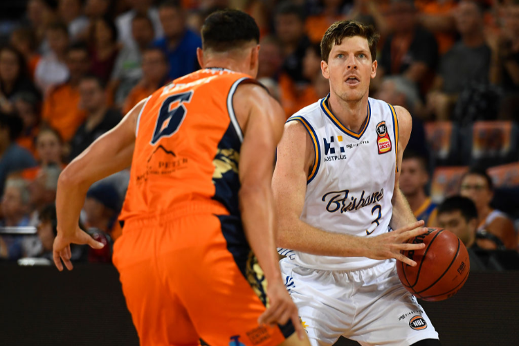 CAMERON GLIDDON of the Bullets looks to get past Jarrod Kenny of the Taipans during the NBL match between the Cairns Taipans and the Brisbane Bullets at Cairns Convention Centre in Cairns, Australia.
