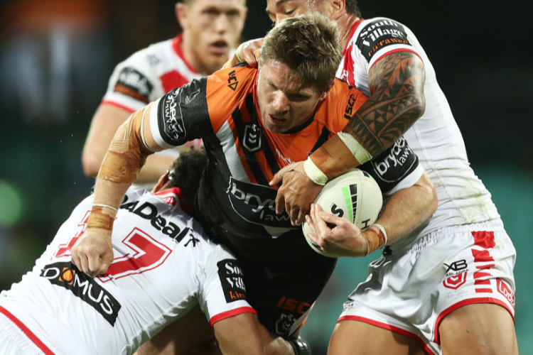 CHRIS LAWRENCE of the Tigers is tackled during the NRL match between the St George Illawarra Dragons and the Wests Tigers at Sydney Cricket Ground in Sydney, Australia.