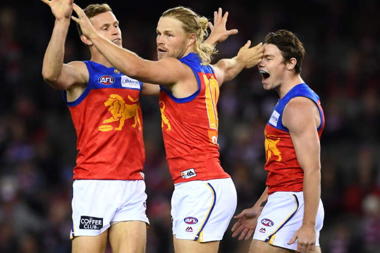 DANIEL RICH of the Lions is congratulated by team mates after kicking a goal during the AFL match between the St Kilda Saints and the Brisbane Lions at Marvel Stadium in Melbourne, Australia.