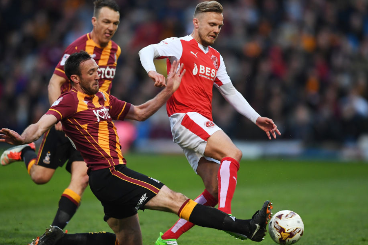 DAVID BALL of Fleetwood Town is tackled by RORY MCARDLE of Bradford City during the Sky Bet League One playoff semi final, first leg match between Bradford City and Fleetwood Town at the Northern Commercials Stadium, Valley Parade in Bradford, England.