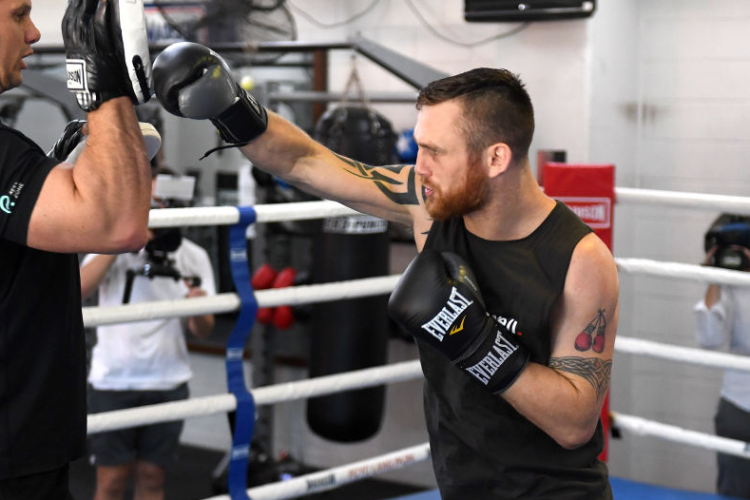Super welterweight boxer DENNIS HOGAN hits the pads during his last public training session before traveling to Mexico to fight Jamie Munguia for the Boxing World Title at the Lang Park PCYC in Brisbane, Australia.