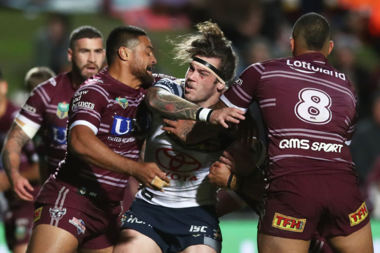 ETHAN LOWE of the Cowboys is tackled during the NRL match between the Manly Sea Eagles and the North Queensland Cowboys at Lottoland in Sydney, Australia.