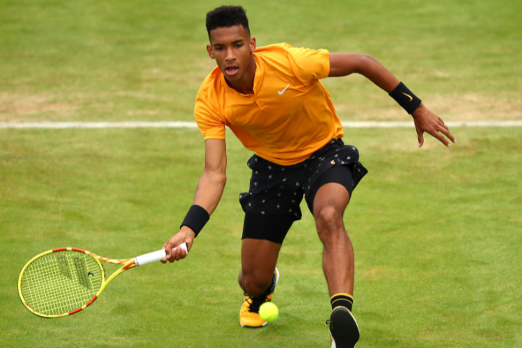 FELIX AUGER-ALIASSIME of Canada plays a forehand during his First Round Singles Match against Grigor Dimitrov of Bulgaria during day Four of the Fever-Tree Championships at Queens Club in London, United Kingdom.