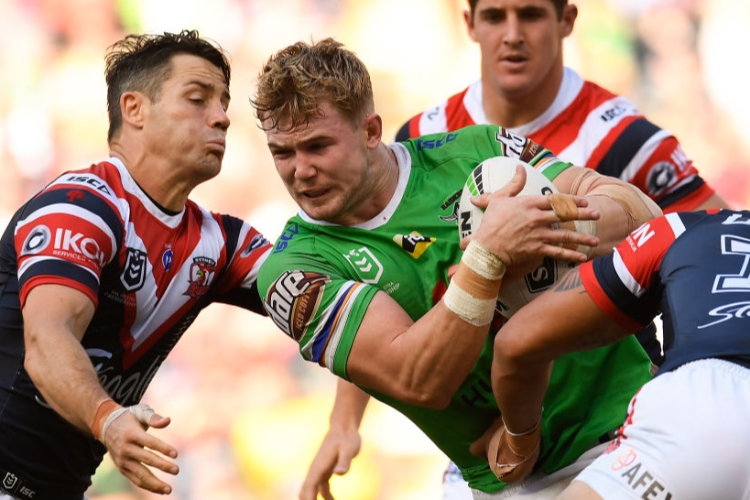 HUDSON YOUNG of the Raiders is tackled during the NRL match between the Sydney Roosters and the Canberra Raiders at Suncorp Stadium in Brisbane, Australia.