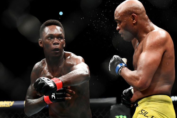 ISRAEL ADESANYA of Nigeria punches ANDERSON SILVA of Brazil during their Middleweight bout during UFC234 at Rod Laver Arena in Melbourne, Australia.