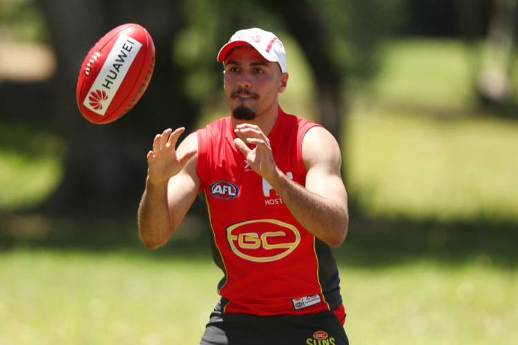 IZAK RANKINE handballs during a Gold Coast Suns AFL training session n Gold Coast, Australia. IZAK RANKINE handballs during a Gold Coast Suns AFL training session n Gold Coast, Australia.