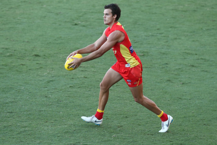 JACK BOWES of the Suns kicks during the AFL pre-season practice match between the Gold Coast Suns and the Brisbane Lions at Metricon Stadium in Gold Coast, Australia.