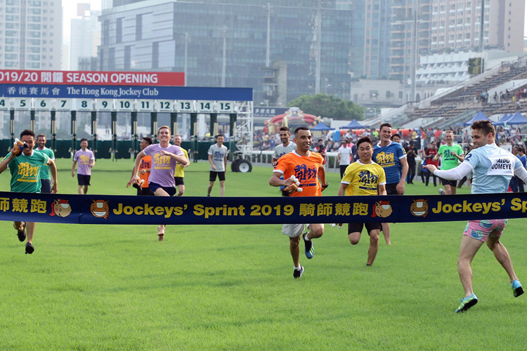 Jockeys dash 100m in front of the grandstand.