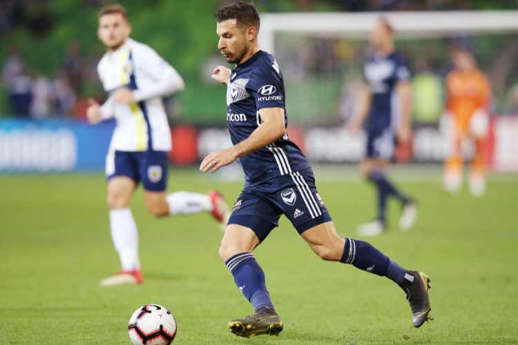 KOSTA BARBAROUSES of the Victory runs with the ball during the A-League match between Melbourne Victory and the Central Coast Mariners at AAMI Park in Melbourne, Australia.
