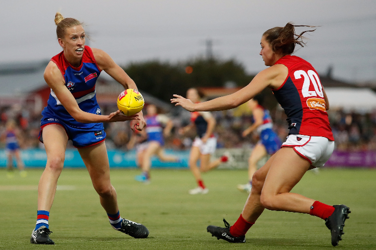 LAUREN SPARK of the Bulldogs handpasses the ball ahead of Claudia Whitfort of the Demons during the 2018 AFLW Round 07 match between the Western Bulldogs and the Melbourne Demons at VU Whitten Oval Melbourne, Australia LAUREN SPARK of the Bulldogs handpasses the ball ahead of Claudia Whitfort of the Demons during the 2018 AFLW Round 07 match between the Western Bulldogs and the Melbourne Demons at VU Whitten Oval Melbourne, Australia