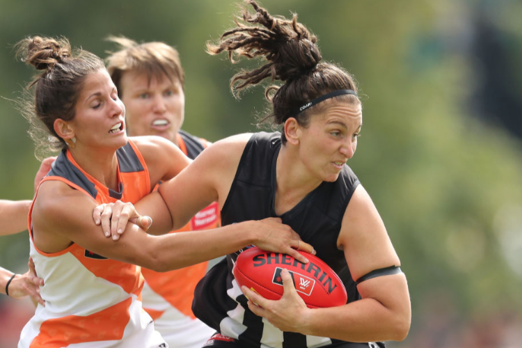 LAUREN TESORIERO of the Magpies is tackled during the AFL Women's match between the Collingwood Magpies and the Greater Western Sydney Giants at Olympic Park in Melbourne, Australia.