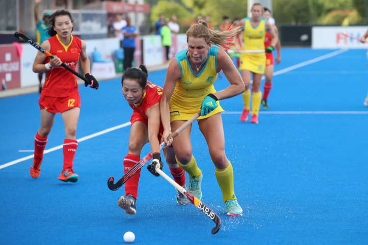 China battles for the ball with MADDY FITZPATRICK of Australia during the Women's FIH Field Hockey Pro League match between China and Australia at Wujin Hockey Stadium in Changzhou, China.