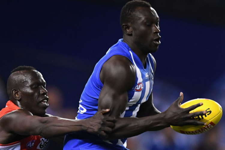 MAJAK DAW of the Kangaroos marks infront of Aliir Aliir of the Swans during the AFL match between the North Melbourne Kangaroos and the Sydney Swans at Etihad Stadium in Melbourne, Australia. MAJAK DAW of the Kangaroos marks infront of Aliir Aliir of the Swans during the AFL match between the North Melbourne Kangaroos and the Sydney Swans at Etihad Stadium in Melbourne, Australia.