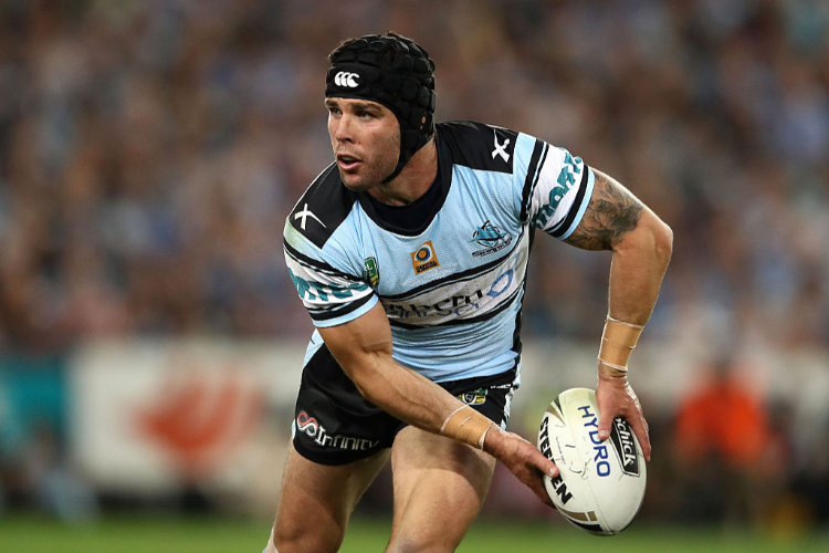 MICHAEL ENNIS of the Sharks offloads the ball during the NRL Grand Final match between the Cronulla Sharks and the Melbourne Storm at ANZ Stadium in Sydney, Australia.
