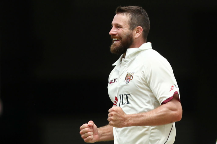 MICHAEL NESER of the Bulls celebrates dismissing Daniel Hughes of NSW during the Sheffield Shield match between Queensland and New South Wales at The Gabba in Brisbane, Australia.