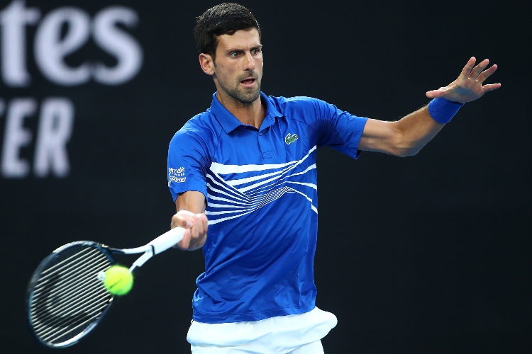 NOVAK DJOKOVIC of Serbia plays a backhand during the Australian Open at Melbourne Park Melbourne, Australia.