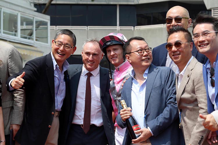 Trainer Paul O'Sullivan celebrates Band Of Brothers' win with his owners. Trainer Paul O'Sullivan celebrates Band Of Brothers' win with his owners.
