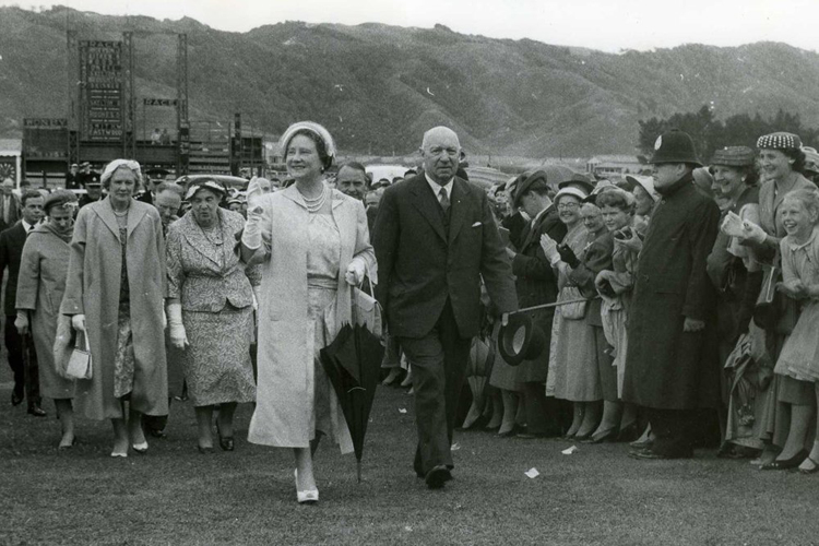 The Queen Mother arriving at Trentham Races accompanied by the President of the Wellington Racing Club, Mr H.R. Chalmers, in 1958.