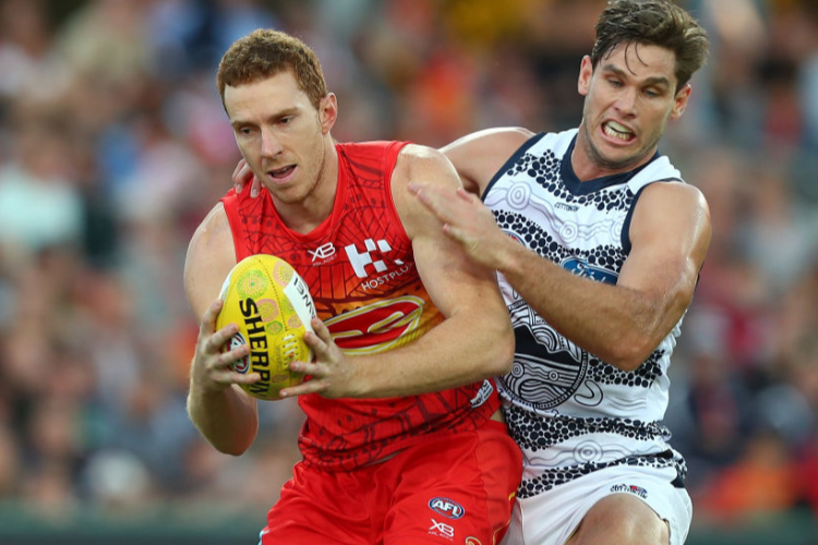 RORY THOMPSON of the Suns takes a mark over Tom Hawkins of the Cats during the AFL match between the Gold Coast Suns and the Geelong Cats at Metricon Stadium in Gold Coast, Australia. RORY THOMPSON of the Suns takes a mark over Tom Hawkins of the Cats during the AFL match between the Gold Coast Suns and the Geelong Cats at Metricon Stadium in Gold Coast, Australia.