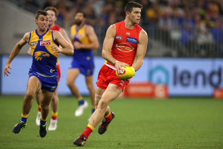 SAM COLLINS of the Suns looks to pass the ball during the AFL match between the West Coast Eagles and the Gold Coast Suns at Optus Stadium in Perth, Australia.