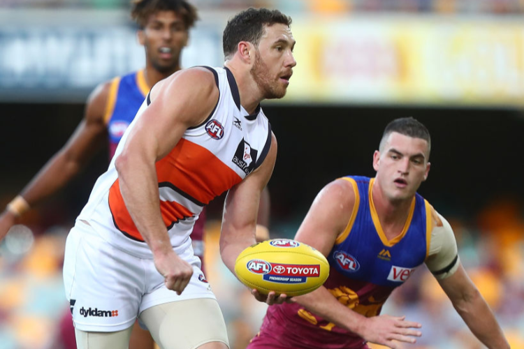 SHANE MUMFORD of the Giants handballs during the AFL match between the Brisbane Lions and the Greater Western Sydney Giants at The Gabba in Brisbane, Australia.