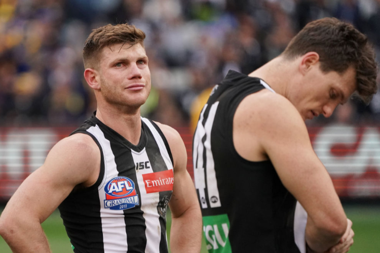 TAYLOR ADAMS of the Magpies looks dejected after defeat during the AFL Grand Final match between the Collingwood Magpies and the West Coast Eagles at MCG in Melbourne, Australia.