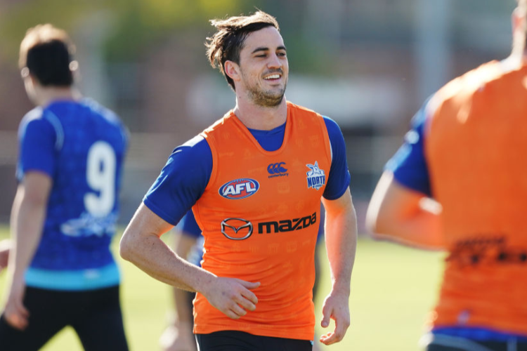 TAYLOR GARNER of the Kangaroos, being investigated for an alleged incident at a Sydney nightspot on Saturday night, looks upfield with the ball during a North Melbourne Kangaroos AFL training session at Arden Street Ground in Melbourne, Australia.