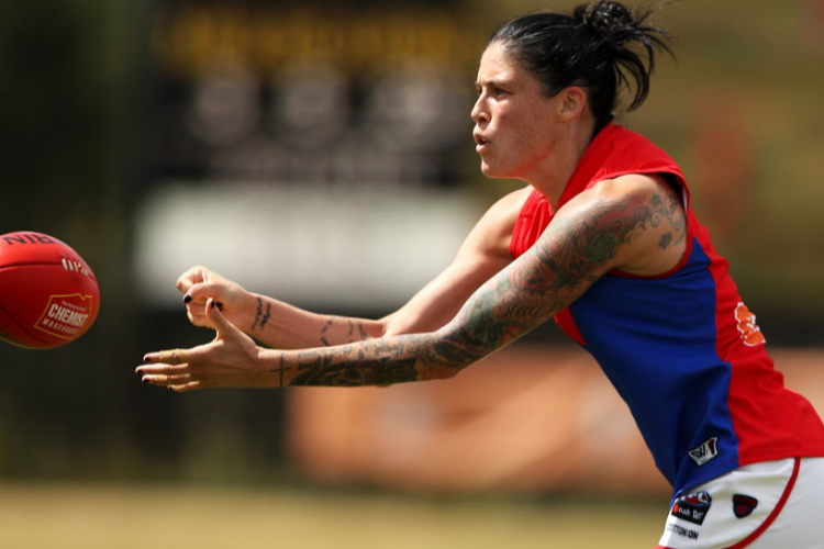 TEGAN CUNNINGHAM of the Demons handballs during the AFLW match between the Greater Western Sydney Giants and the Melbourne Demons at Blacktown International Sportspark in Sydney, Australia. TEGAN CUNNINGHAM of the Demons handballs during the AFLW match between the Greater Western Sydney Giants and the Melbourne Demons at Blacktown International Sportspark in Sydney, Australia.