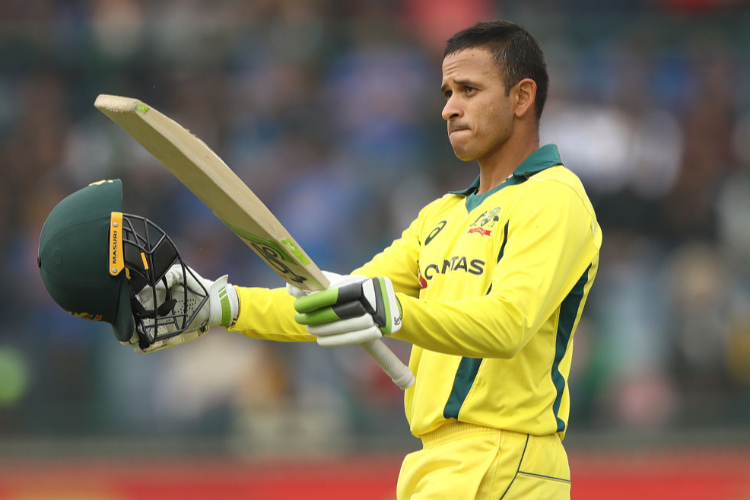 USMAN KHAWAJA of Australia celebrates scoring his century during the One Day International series between India and Australia at Feroz Shah Kotla Ground in Delhi, India.