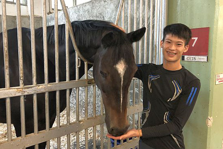 Rising star Simon Kok Wei Hoong cuddles up to his pet horse Autumn Rush.