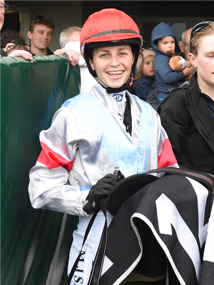 Apprentice jockey Maria Sanson is all smiles after her first raceday victory aboard Super Flash

