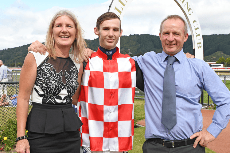 Jockey Shaun McKay celebrates his first Group One win with his parents Kim and Peter