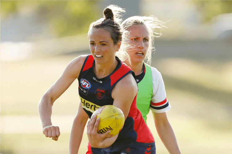 DAISY PEARCE handballs during a Melbourne Demons AFLW training session at Gosch's Paddock in Melbourne, Australia.