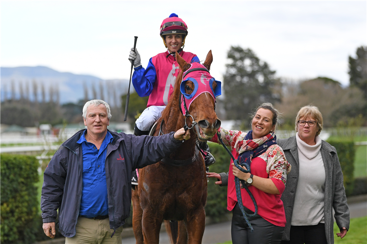 Chrissy Bambry poses with her parents Tony and Judith and jockey Leah Hemi as they celebrate the win of the Bambry family-owned Deerfield