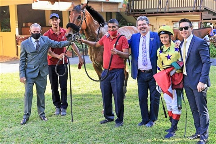 Benny Woodworth celebrates his return to the winner's circle with Mauritius connections, trainer Simon Jones on the left, owners Gavin Glover and Joey Foo Kune flanking Woodworth