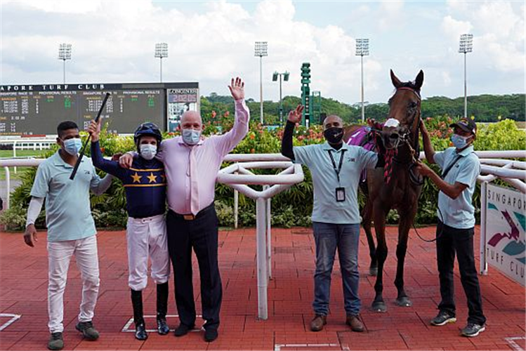 Jockey Danny Beasley and trainer Daniel Meagher celebrate Lim's Lightning's momentous win with stable staff.