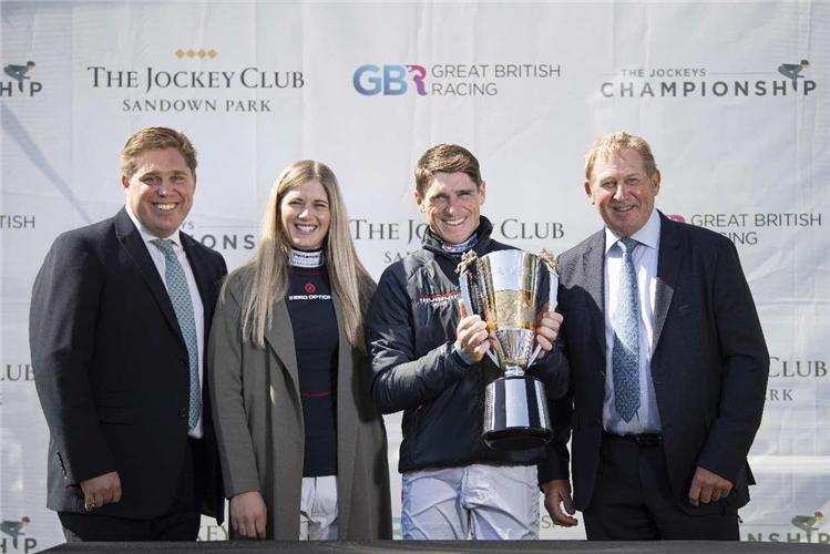 Harry Skelton with the champion jump jockey trophy with brother Dan Skelton (L) his wife Bridget Andrews and father Nick Skelton (R)