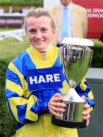 Hollie Doyle holds up the trophy after Trueshan won.
